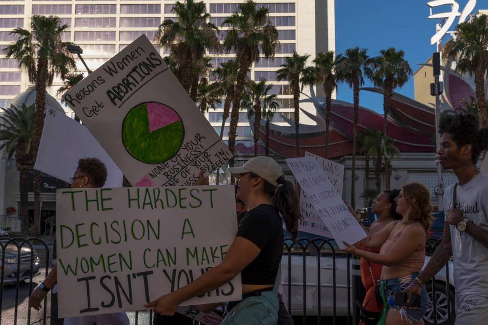 Protesters pass Flamingo Las Vegas during a rally for women’s rights, Friday, July 1, 20 ...