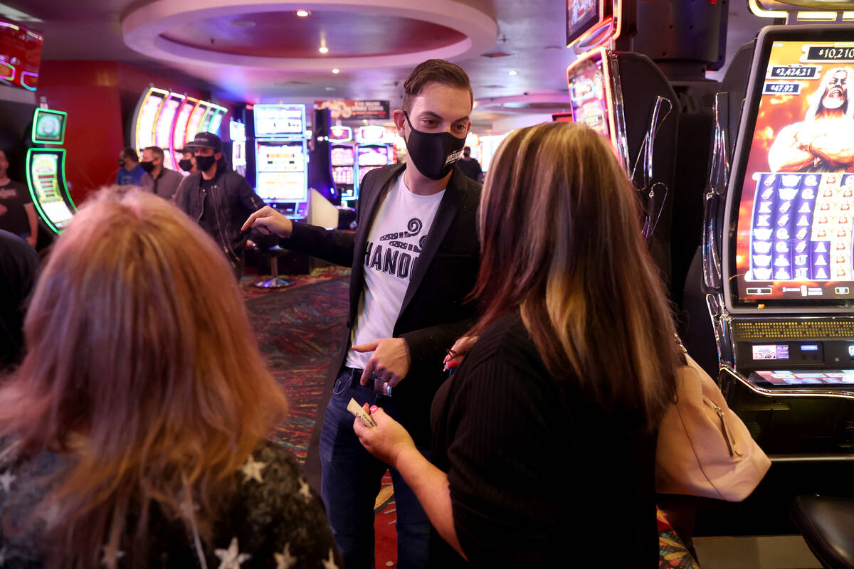 Slot machine YouTuber Brian Christopher visits with Marci Sain, left, and Connie Thomas, both o ...