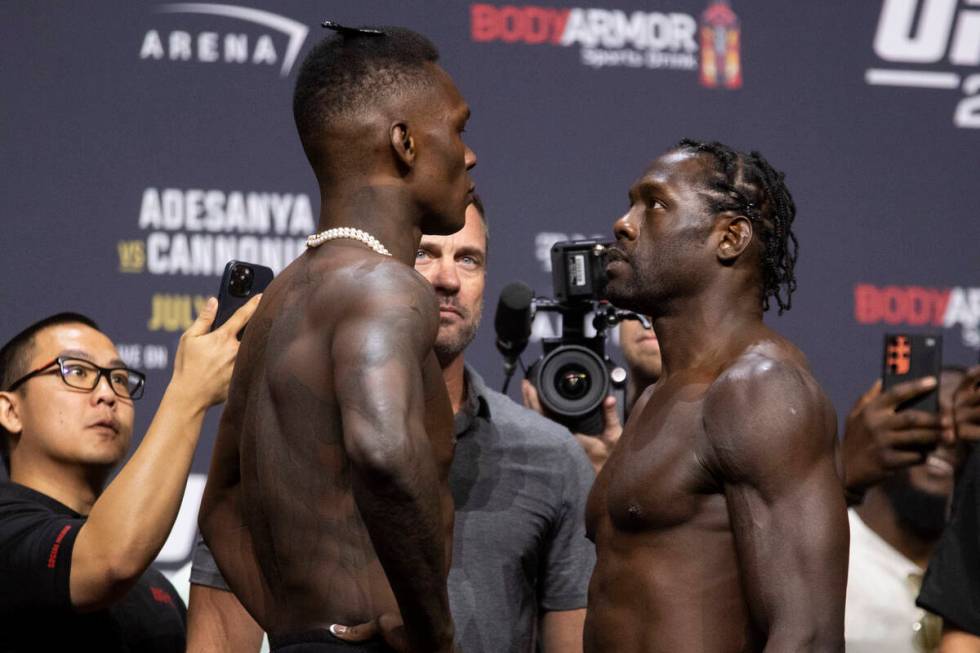 Israel Adesanya, left, and Jared Cannonier, face off during an UFC 276 weigh-in event at T-Mobi ...