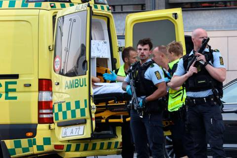 An ambulance and armed police outside the Field's shopping center, in Orestad, Copenhagen, Denm ...