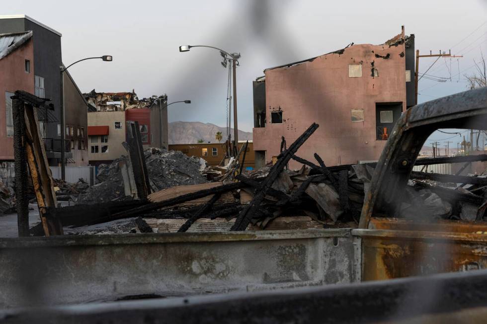 Burned remnants of Urban Lofts Townhomes are fenced off on Wednesday, June 29, 2022, in downtow ...