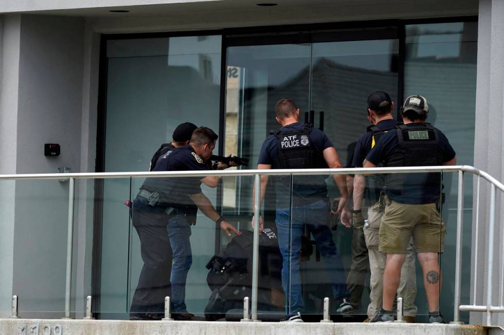 Law enforcement search in a building after a mass shooting at the Highland Park Fourth of July ...