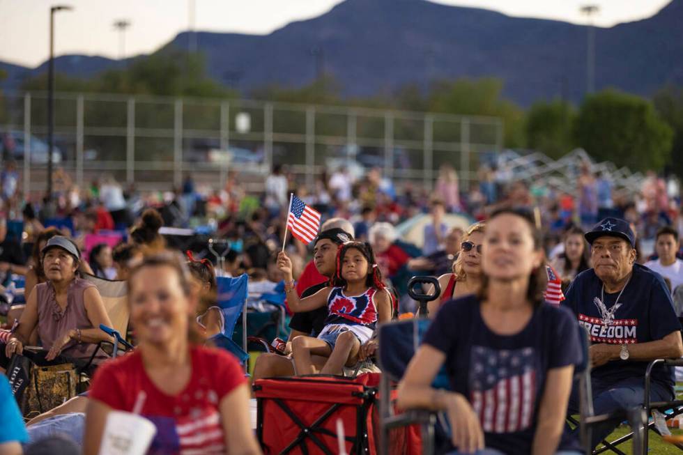 Emily Sandoval, holding flag, 9, waits for the fireworks to start during a Fourth of July celeb ...