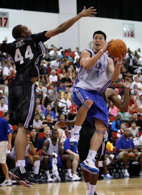 Jeremy Lin of the Mavericks goes up for a shot against JP Prince of the Wizards during their ga ...