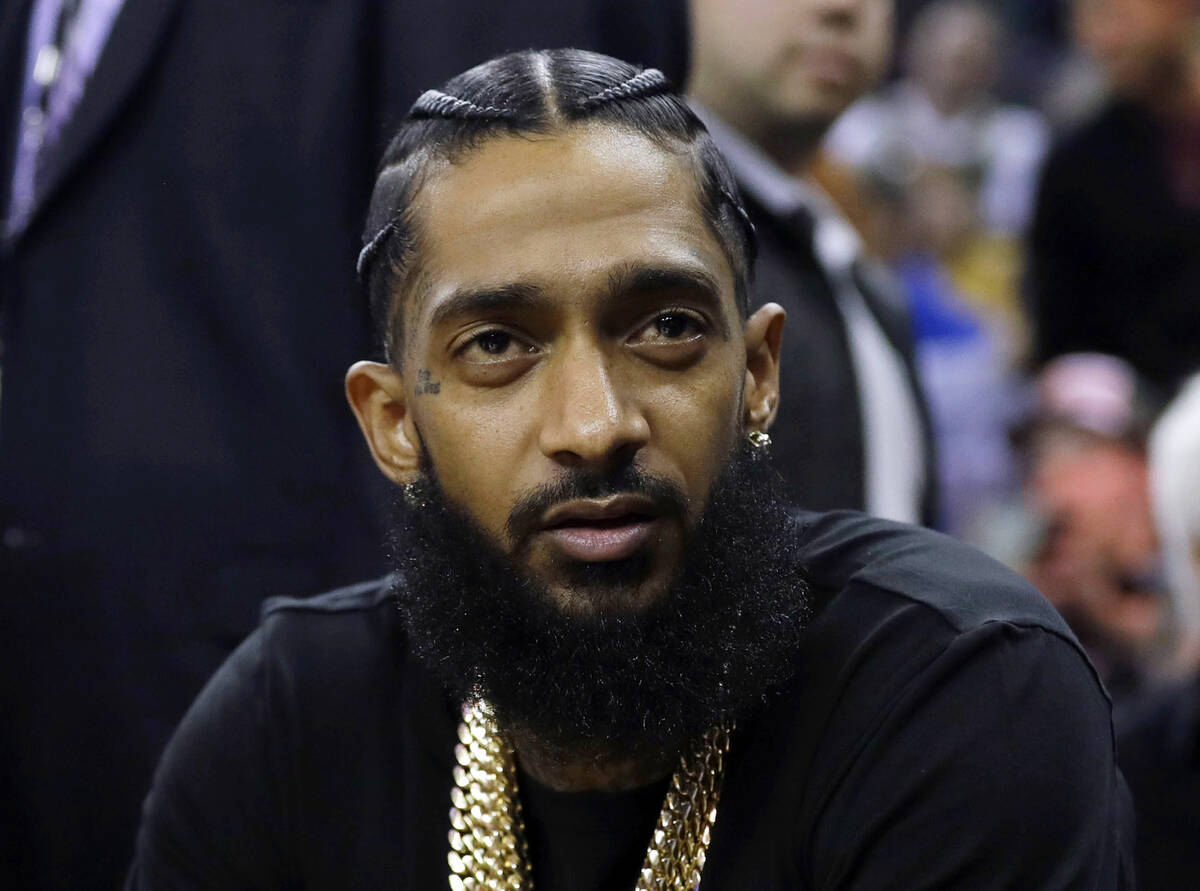 Rapper Nipsey Hussle attends an NBA basketball game between the Golden State Warriors and the M ...