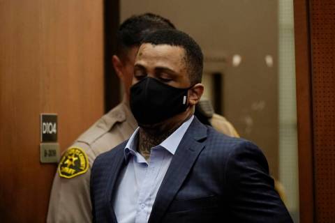 Eric Holder Jr., who is accused of killing rapper Nipsey Hussle, enters a courtroom to hear the ...
