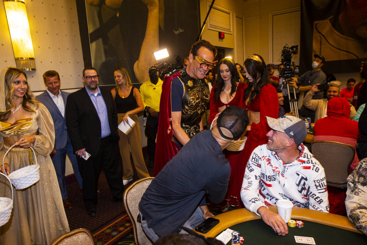 Actor and World Series of Poker master of ceremonies Vince Vaughn greets poker player Phil Ivey ...