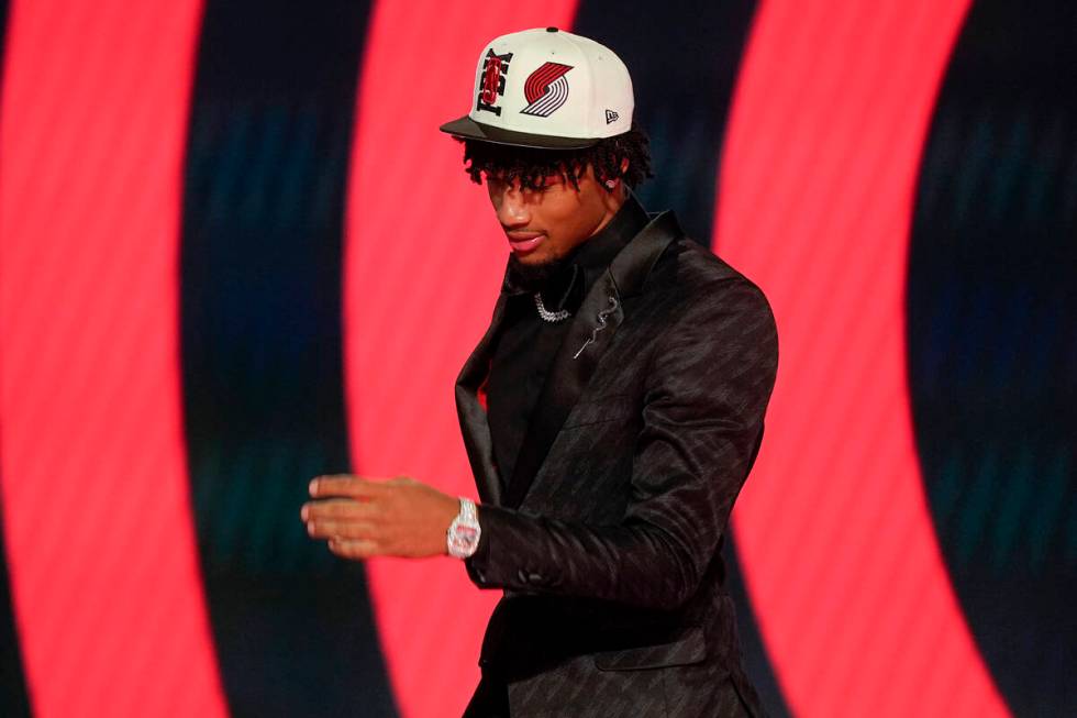 Shaedon Sharpe walks across the stage after being selected seventh overall by the Portland Trai ...