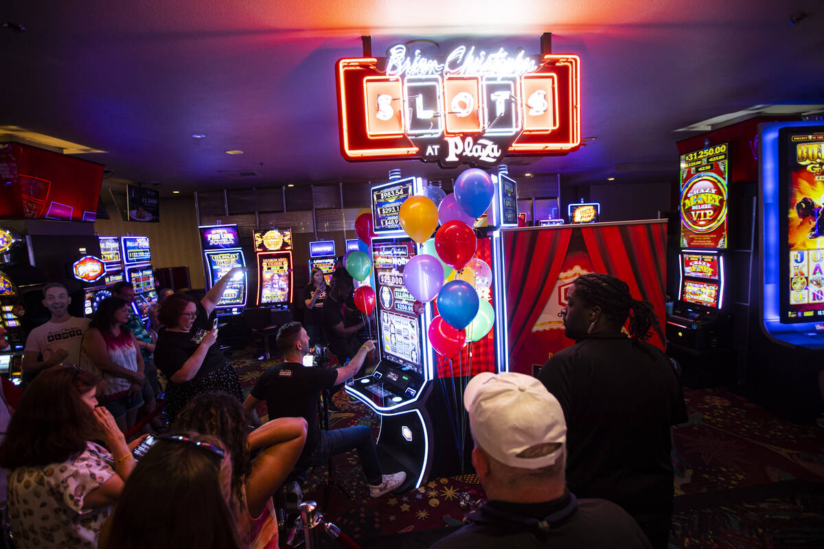 YouTuber Brian Christopher, center left, plays on his new slot machine Brian Christopher's Pop' ...