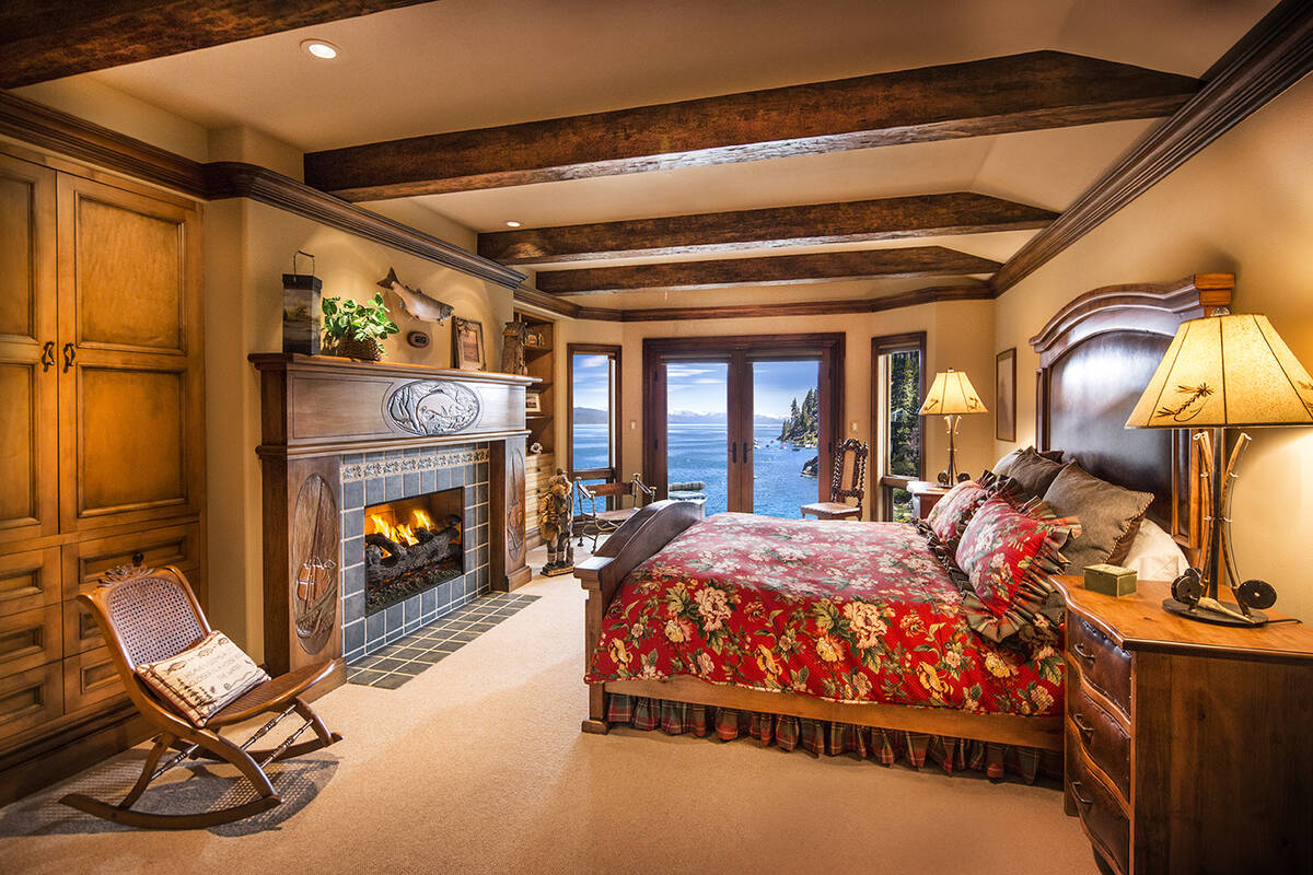 A bed room features one of 13 fireplaces in the home. (Chase International Realty)