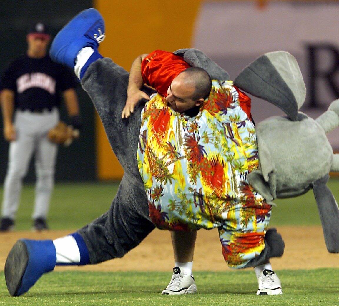 Mike Carroll tosses Las Vegas 51s mascot Cosmo during the "Beat The Mascot" race between inning ...