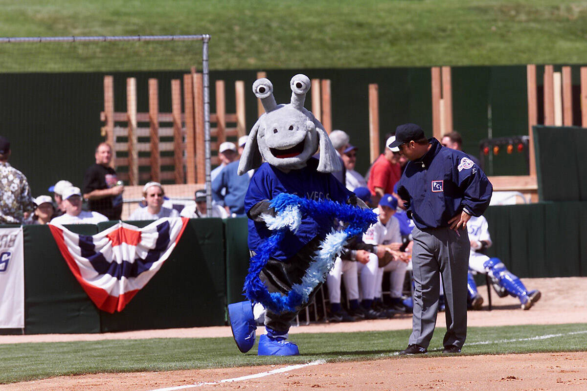 Las Vegas 51s mascot Cosmo flirts with an umpire in front of the "Party Zone" on the third base ...