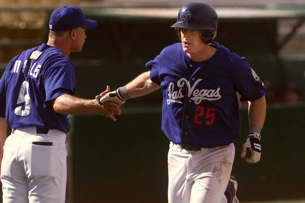 Las Vegas third baseman Rick Bell, right, is congratulated by 51s manager Brad Mills as he roun ...