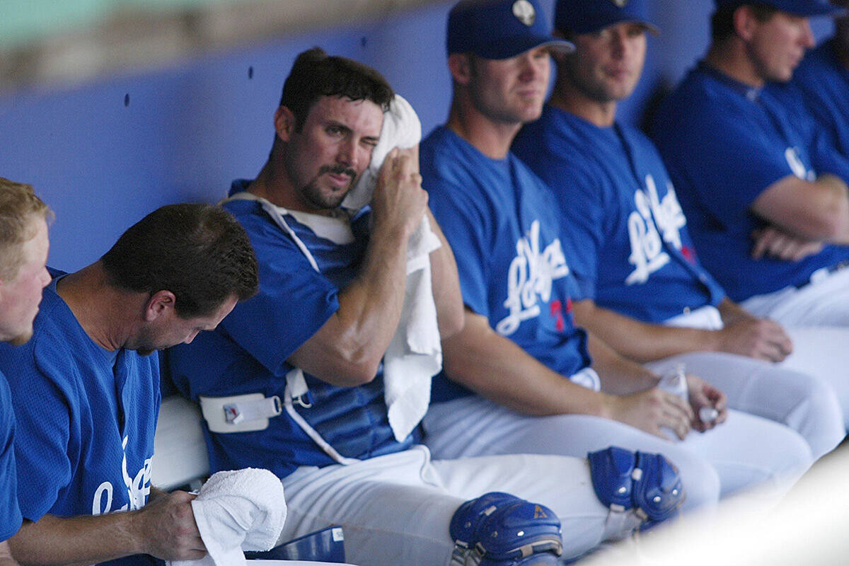 Las Vegas 51s catcher Tommy Davis wipes sweat from his face Sunday, August 18, 2002, in the dug ...
