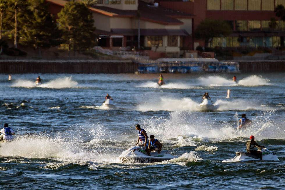 Jetskiers cruise across along the Colorado River near Bullhead City Community Park in May 2020. ...