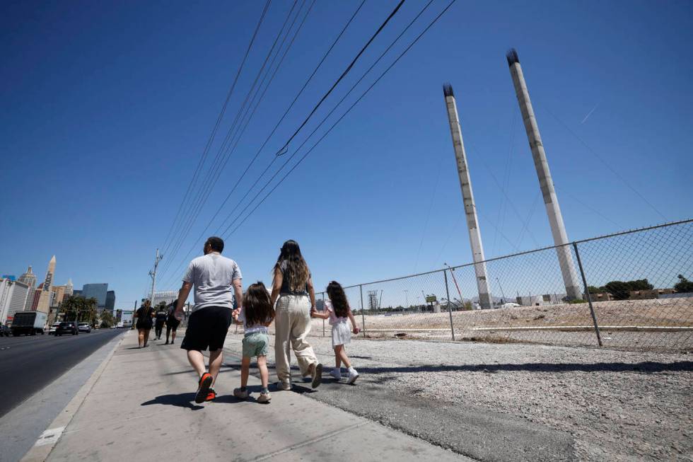 Pedestrians pass by the partially built SkyVue observation-wheel project, Friday, May 13, 2022, ...