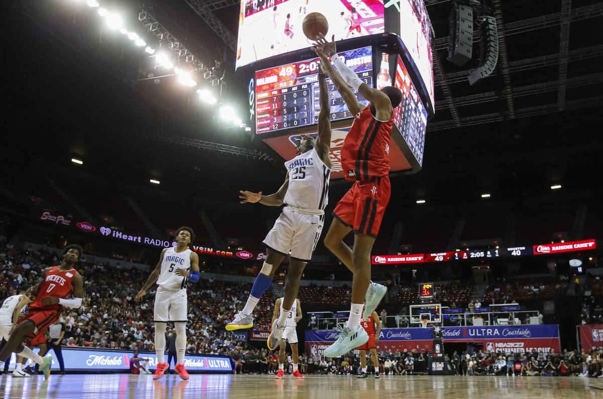 Houston Rockets' Jabari Smith shoots under pressure from Orlando Magic’s Admiral Schofie ...
