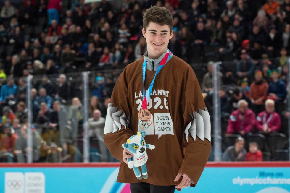 Czech hockey player Matyas Sapovaliv receives the bronze medal after the ice hockey men's mixed ...