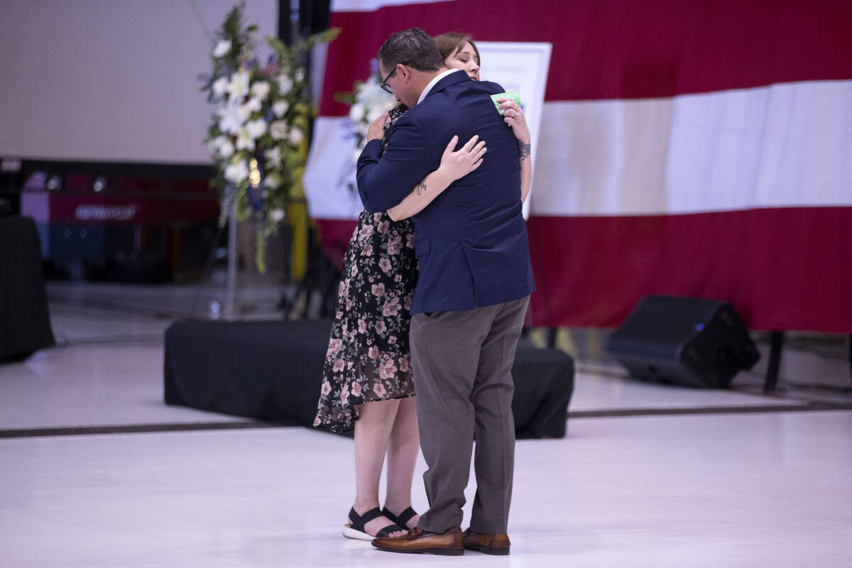 Jessica Cortez, left, embraces Chris Fellure, father of Brooklynn Fellure, a veteran who died i ...