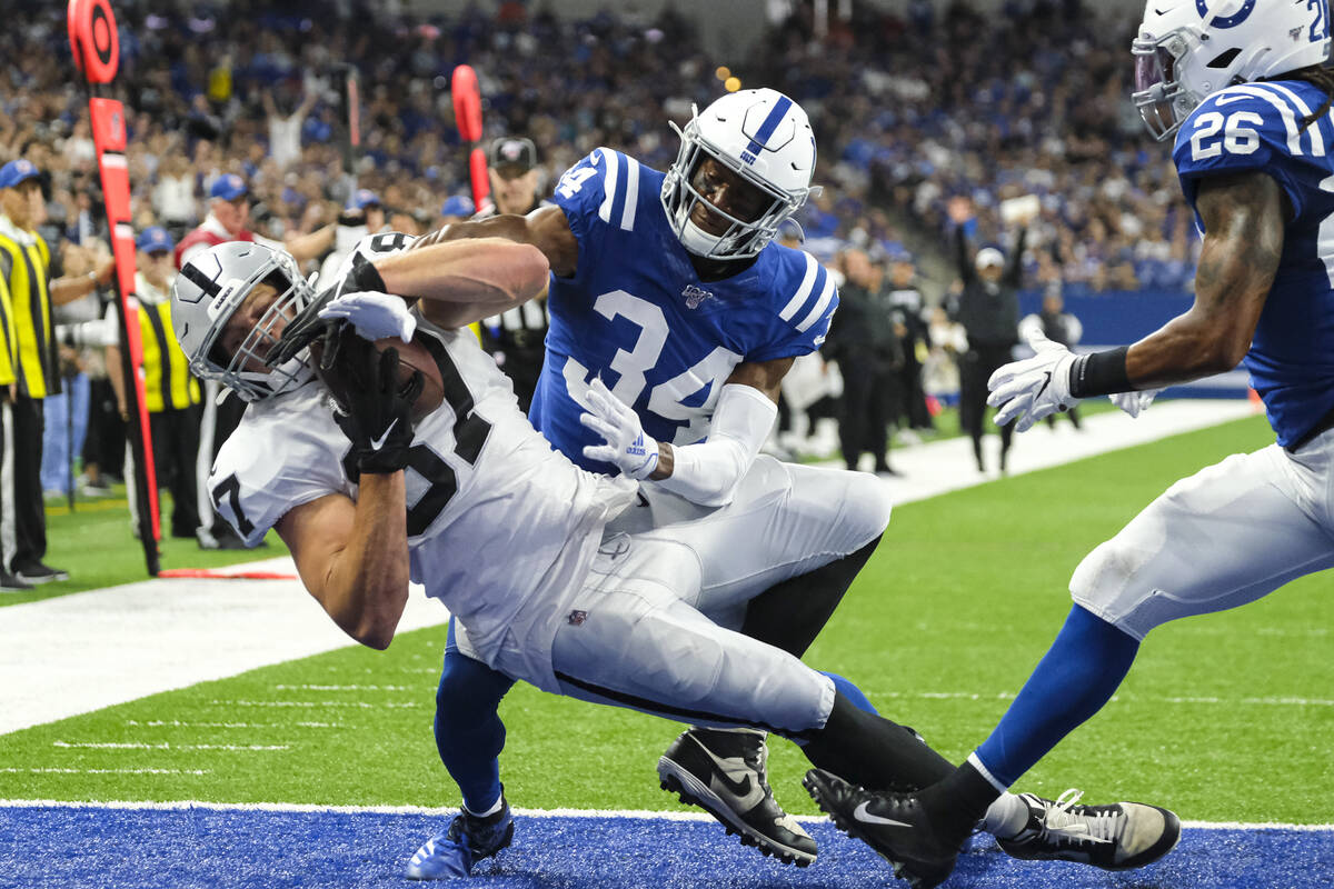 Oakland Raiders tight end Foster Moreau (87) makes a catch for a touchdown in front of Indianap ...