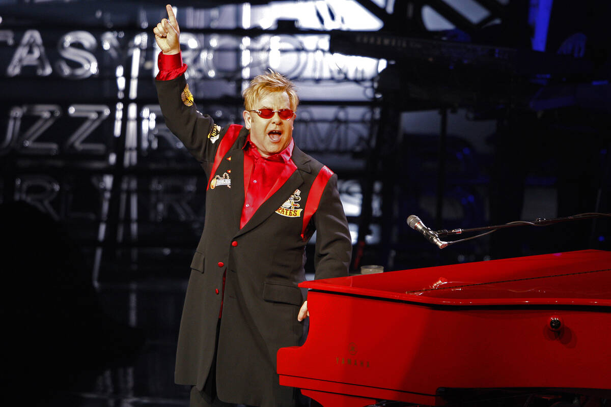 Elton John greets the audience during his final "The Red Piano" show at The Colosseum inside Ca ...