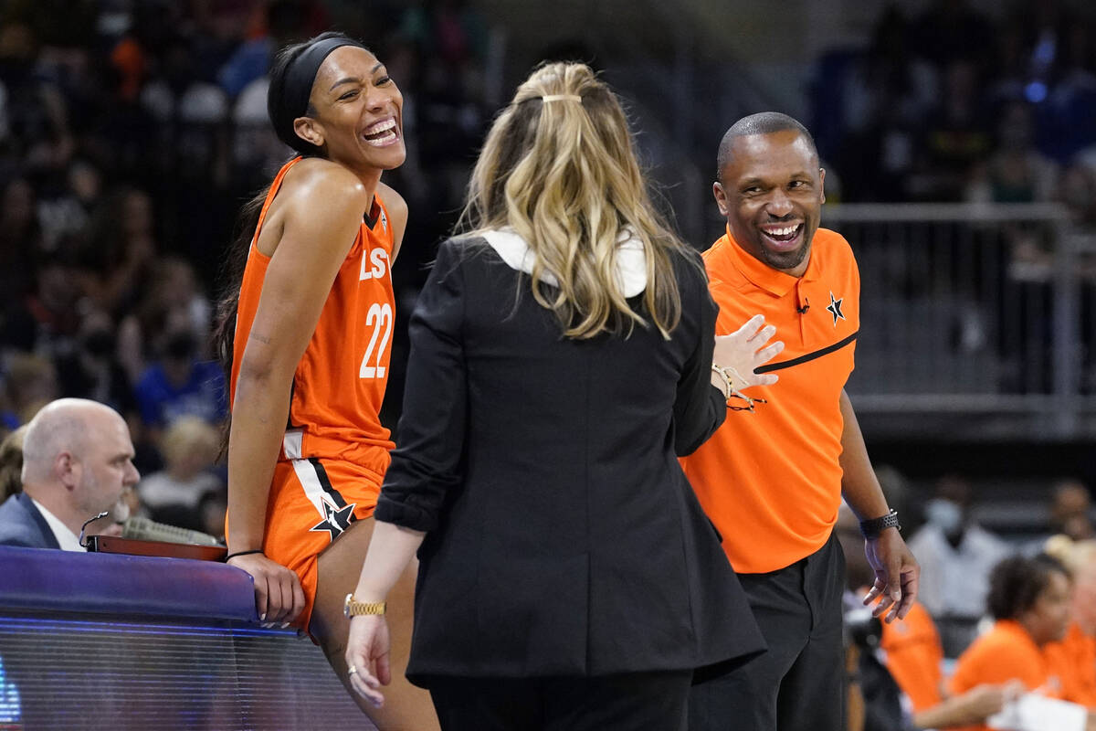 Team Wilson's A'ja Wilson, left, and Team Stewart head coach James Wade, right, smile as they t ...