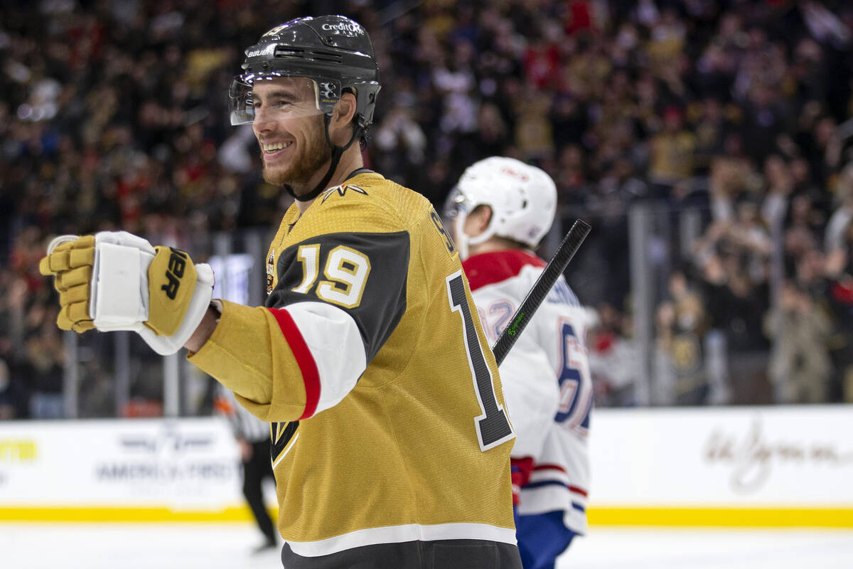 Golden Knights right wing Reilly Smith (19) skates to celebrate with center Jonathan Marchessau ...