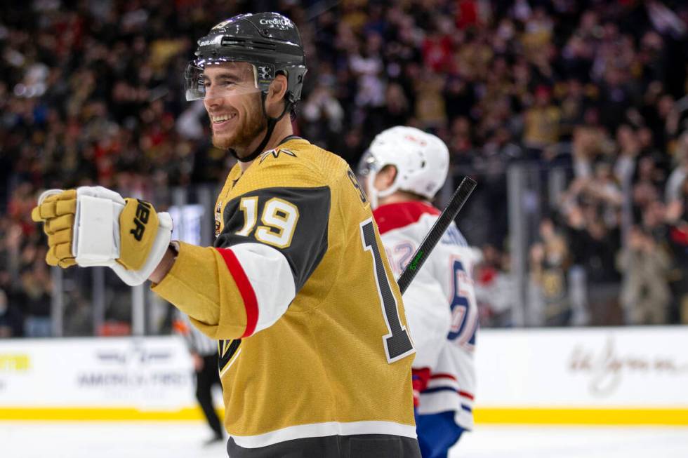 Golden Knights right wing Reilly Smith (19) skates to celebrate with center Jonathan Marchessau ...