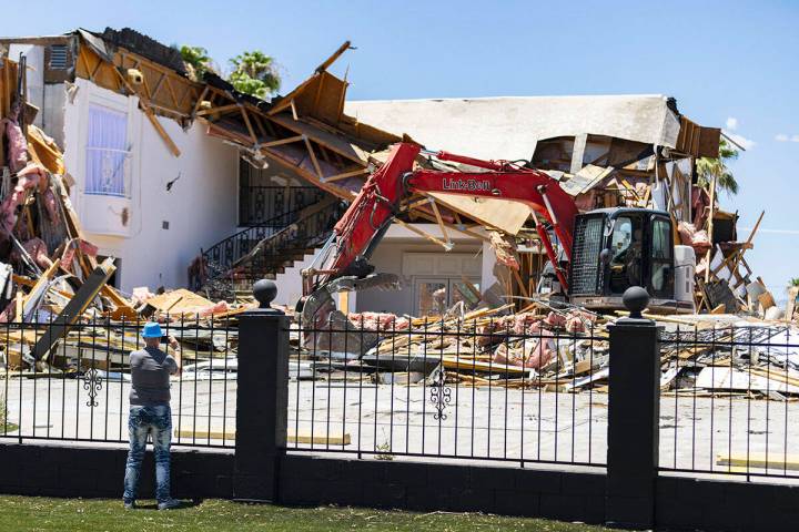 Brian Paco Alvarez takes a photo of the torn down Hartland Mansion on South 6th Street in Downt ...