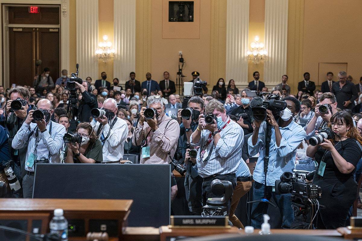 Photographers point their lenses toward the committee as members walk in to start the aHouse se ...