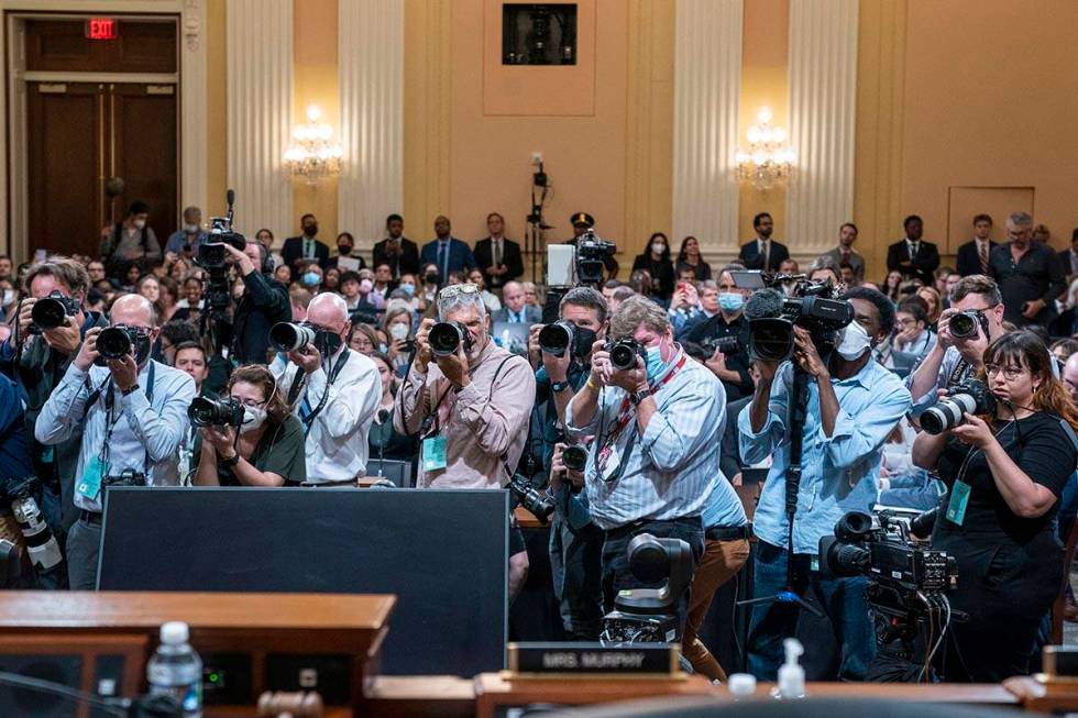 Photographers point their lenses toward the committee as members walk in to start the aHouse se ...