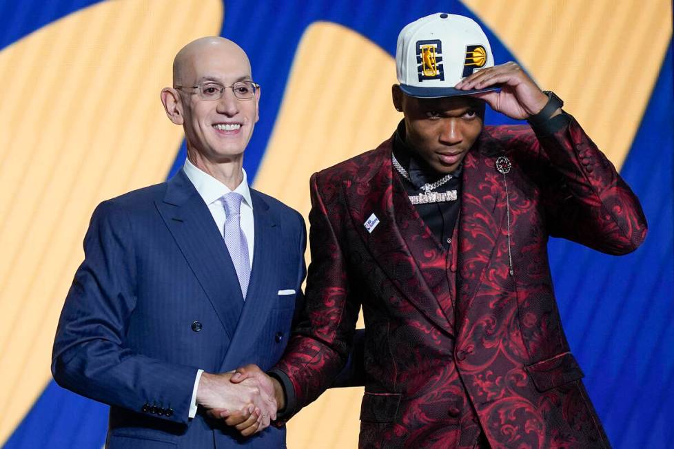 Bennedict Mathurin poses for a photo with NBA Commissioner Adam Silver after being selected six ...