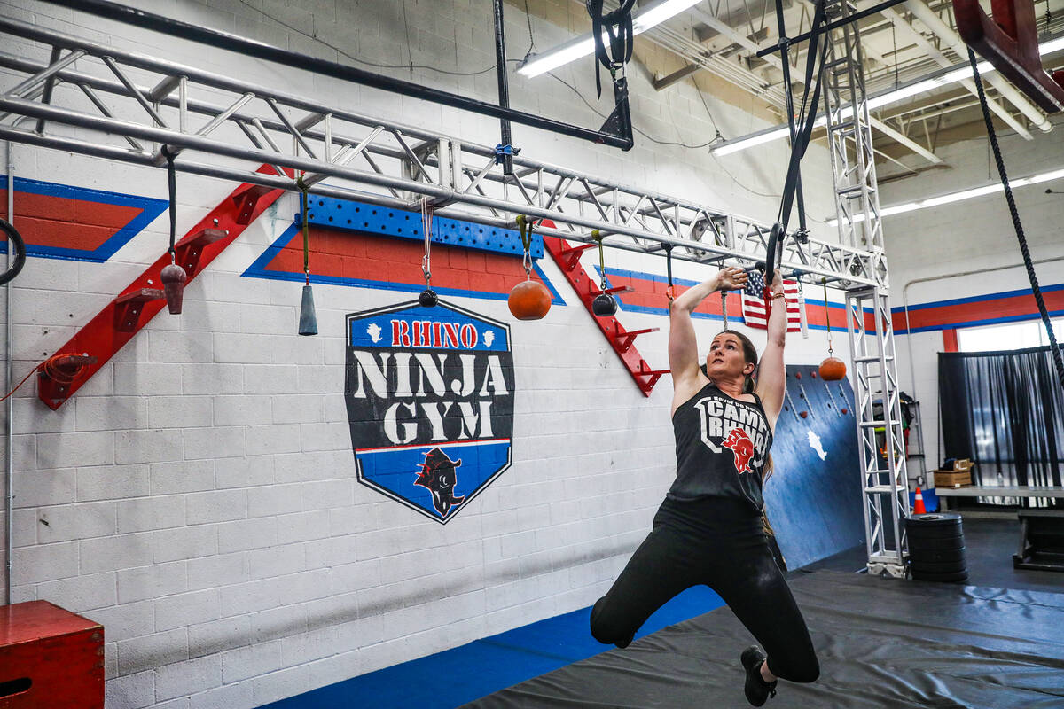 Owner Julie Johnston swings in an obstacle course at Rhino Ninja Gym in Las Vegas, Sunday, July ...