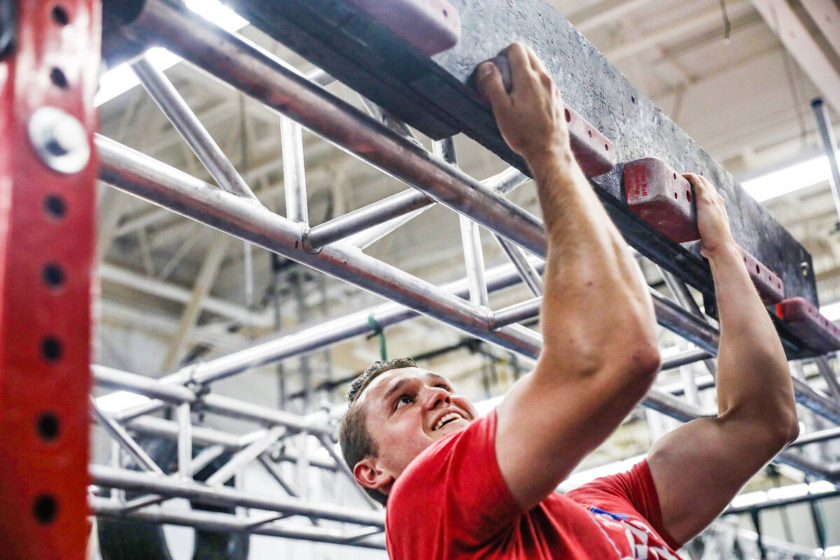 Manager Parker Gatewood shows how to perform the cliffhanger obstacle at Rhino Ninja Gym in Las ...