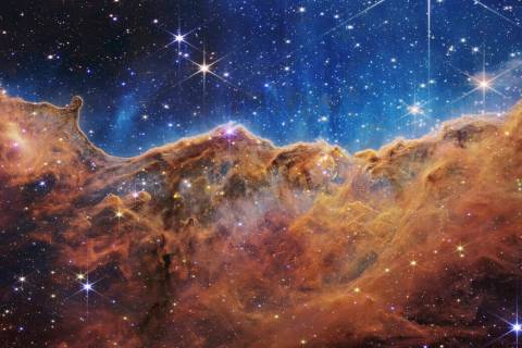 This image released by NASA on Tuesday, July 12, 2022, shows the edge of a nearby, young, star- ...