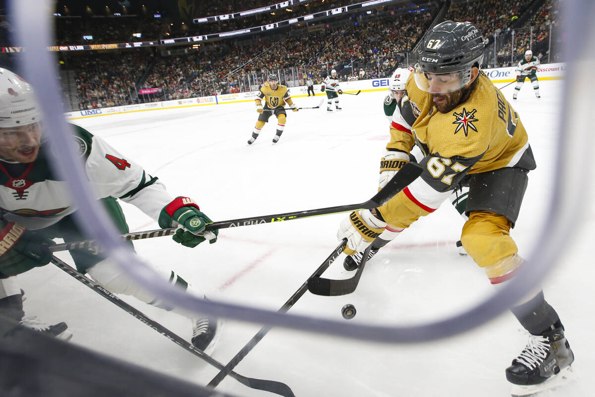 Minnesota Wild defenseman Jon Merrill (4) and Golden Knights left wing Max Pacioretty (67) batt ...