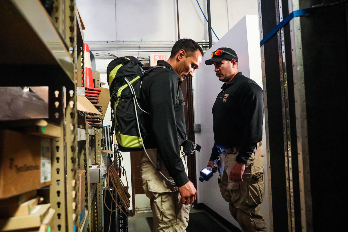 Robert Schumann, a North Las Vegas police officer, left, works with Everett Bates, a Las Vegas ...