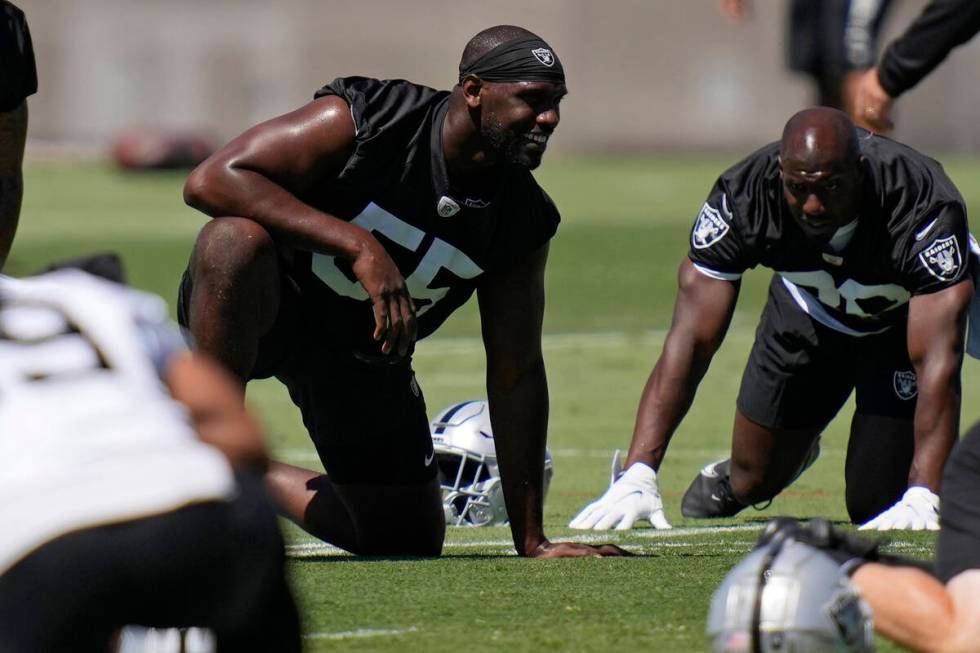 Las Vegas Raiders defensive end Chandler Jones, left, warms up during practice at the NFL footb ...