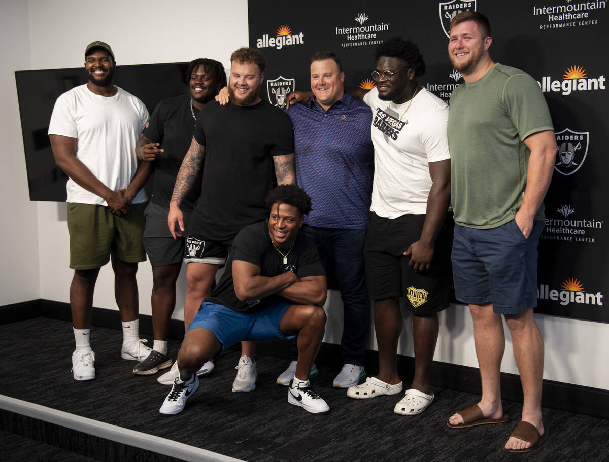 Las Vegas Raiders offensive guard Richie Incognito, center, poses for photos with some of his t ...