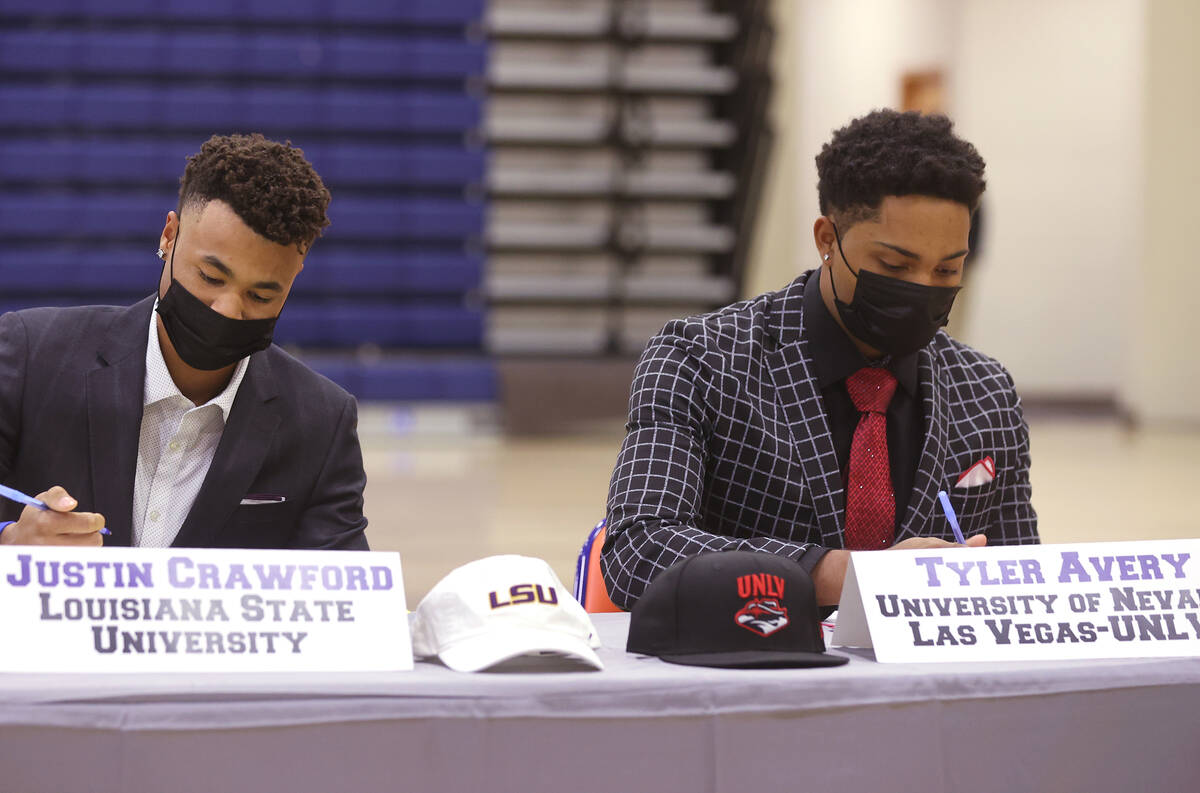 Justin Crawford, left, signs a national letter of intent to play baseball at LSU, while Tyler A ...