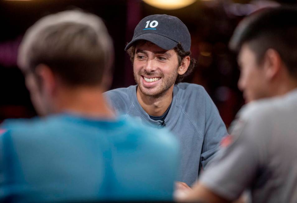 Player Philippe Souki laughs as others talk during final table play at the WSOP Main Event with ...