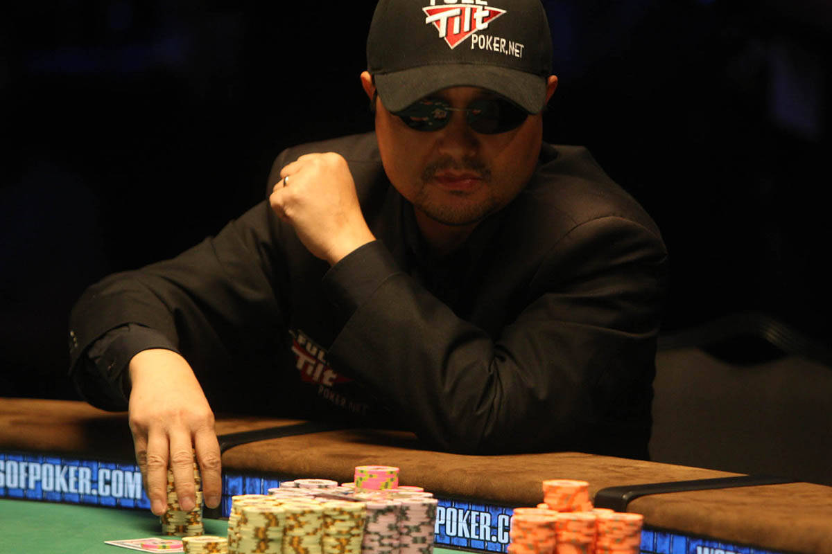 Poker player Jerry Yang of Temecula, California, handles his chips while playing at the final t ...