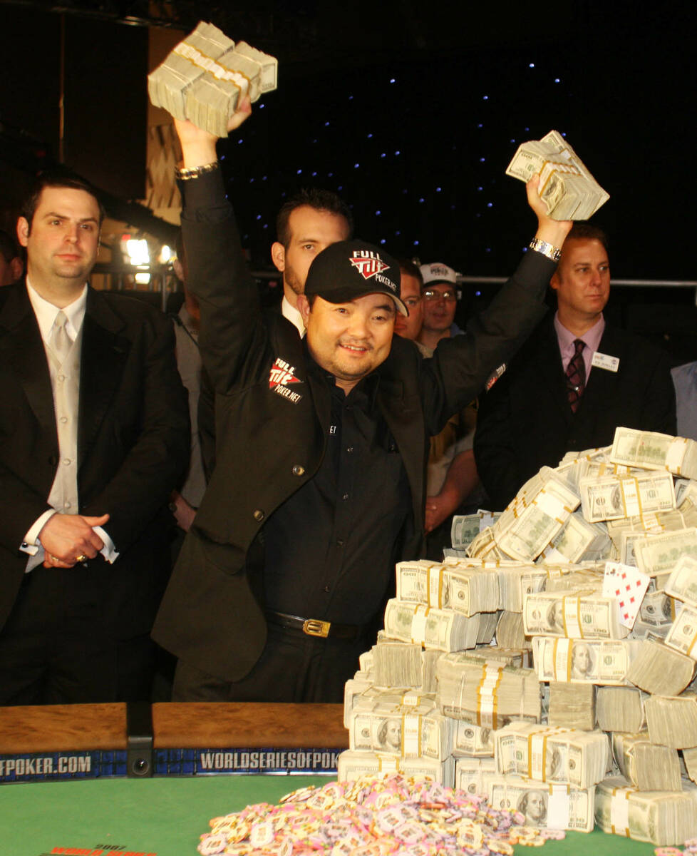 Jerry Yang of Temecula, Calif., holds part of his $8.25 million above his head after winning th ...