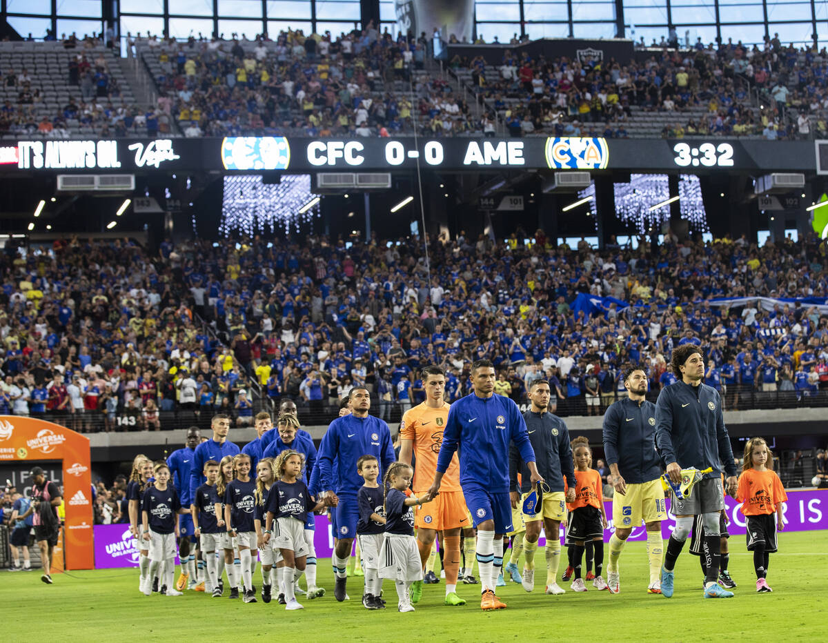 Chelsea and Club América players take the field before the start of a soccer game on Satur ...
