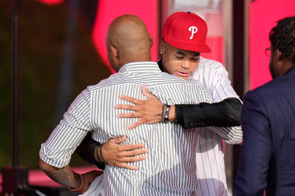 Justin Crawford, right, hugs his father, Carl Crawford, after being selected by the Philadelphi ...