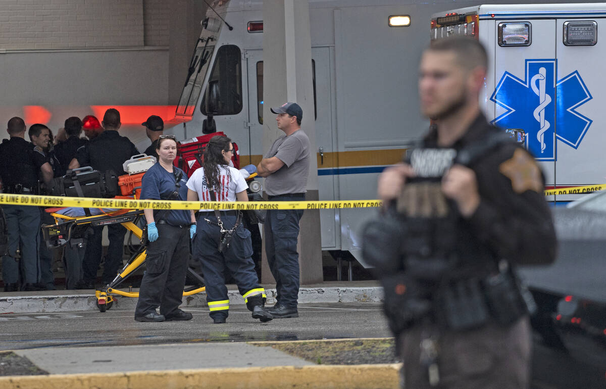 Emergency personnel gather after a deadly shooting Sunday, July 17, 2022, at the Greenwood Park ...