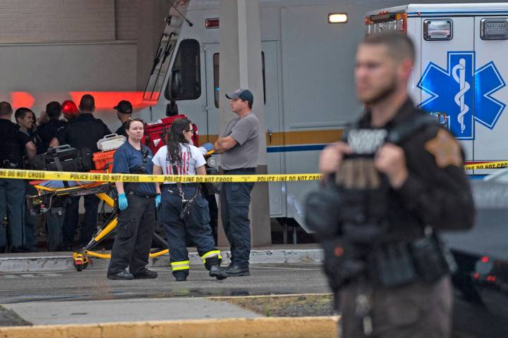 Emergency personnel gather after a deadly shooting Sunday, July 17, 2022, at the Greenwood Park ...