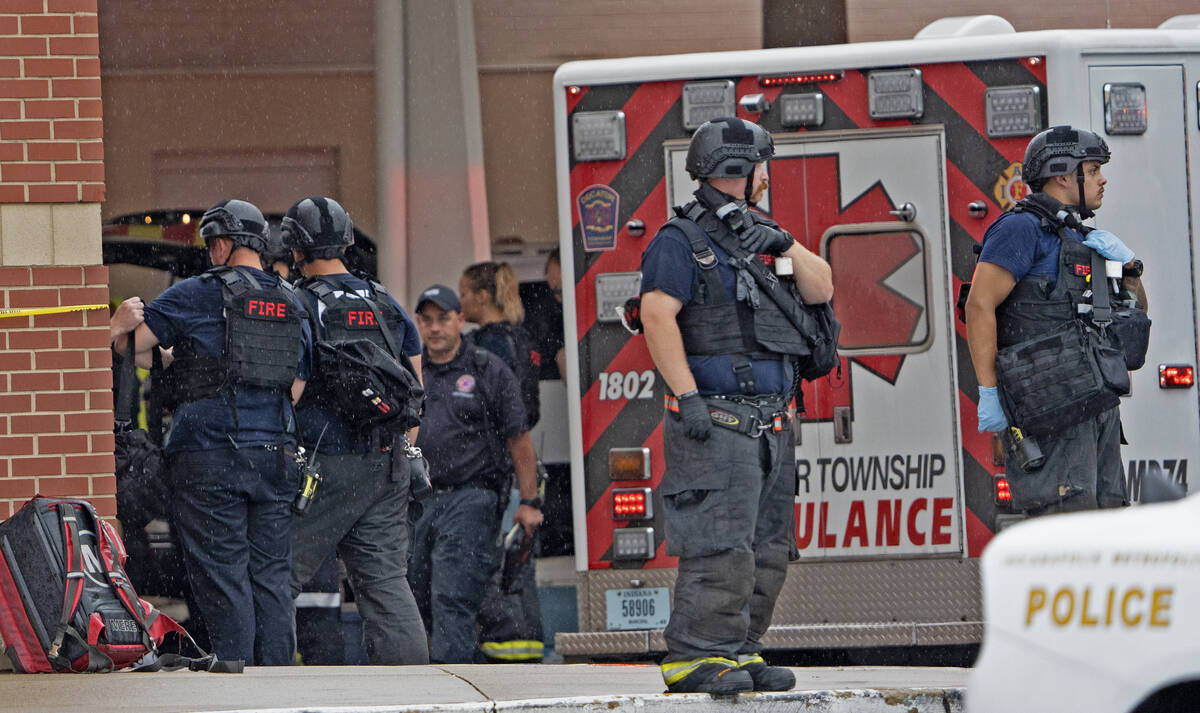 Law enforcement wait outside after a deadly shooting Sunday, July 17, 2022, at the Greenwood Pa ...