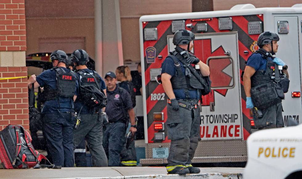 Law enforcement wait outside after a deadly shooting Sunday, July 17, 2022, at the Greenwood Pa ...