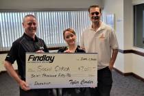 Tyler Corder, left, CFO of Findlay Automotive Group, presents a check for $7,050 to Carly Sheri ...